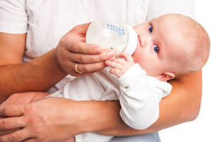 baby-being-fed-bottle-by-father